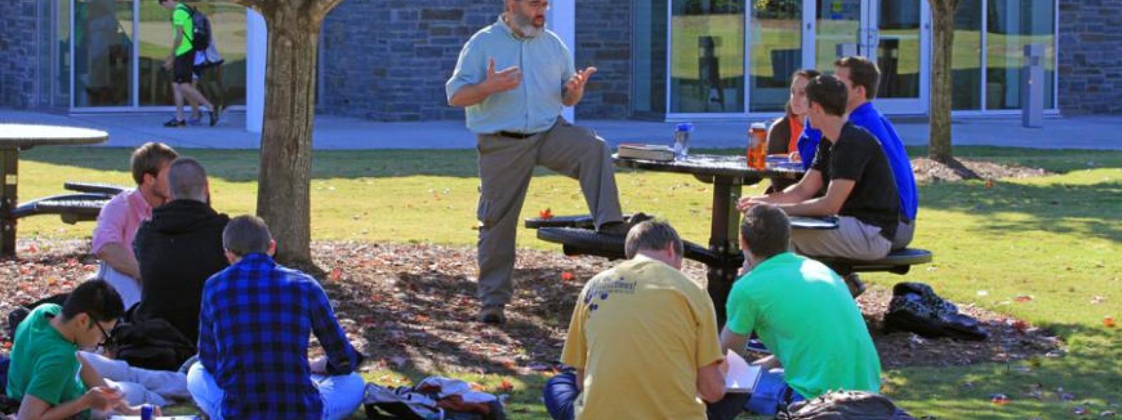 A CIU Professor teaches a class on the quad.